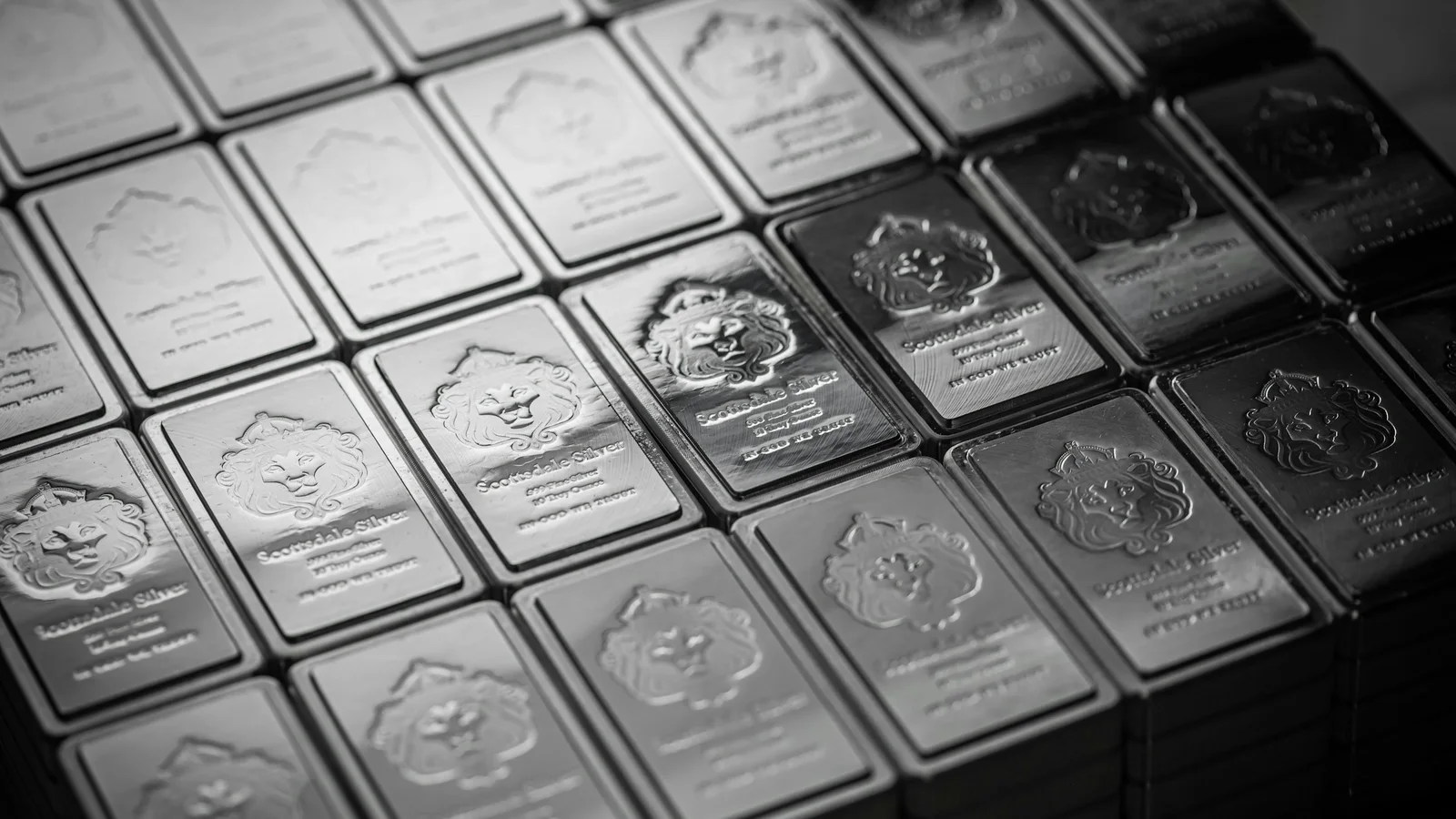 Rows of real Scottsdale Mint silver bars photographed in monochrome